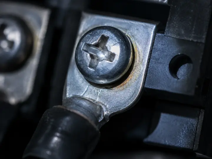 Extreme close-up of an electrical connection showing faint early-stage discoloration, the subtle detail a five-minute inspection is designed to catch.